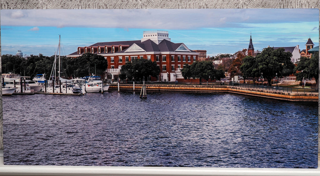 Harbor scene with boats and a large building in the background